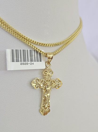 Close-up of 10K yellow gold Jesus cross pendant on Franco chain necklace