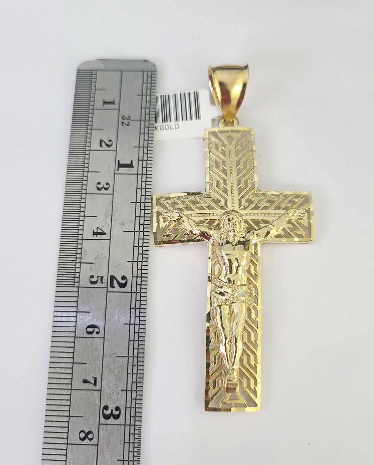 Side angle view of 10K yellow gold Jesus crucifix pendant on Franco chain