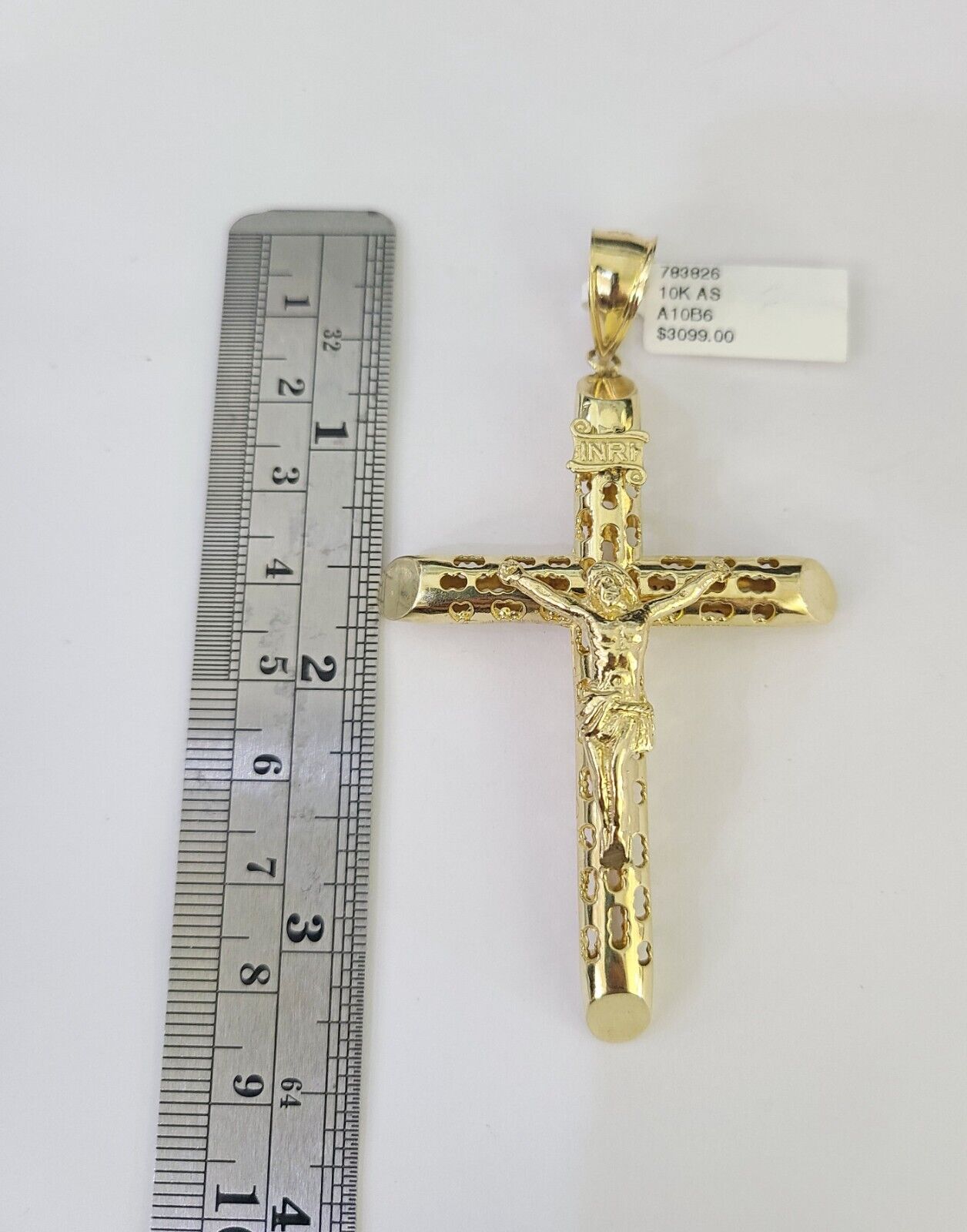 Front view of INRI cross pendant necklace in 10K gold with Franco chain
