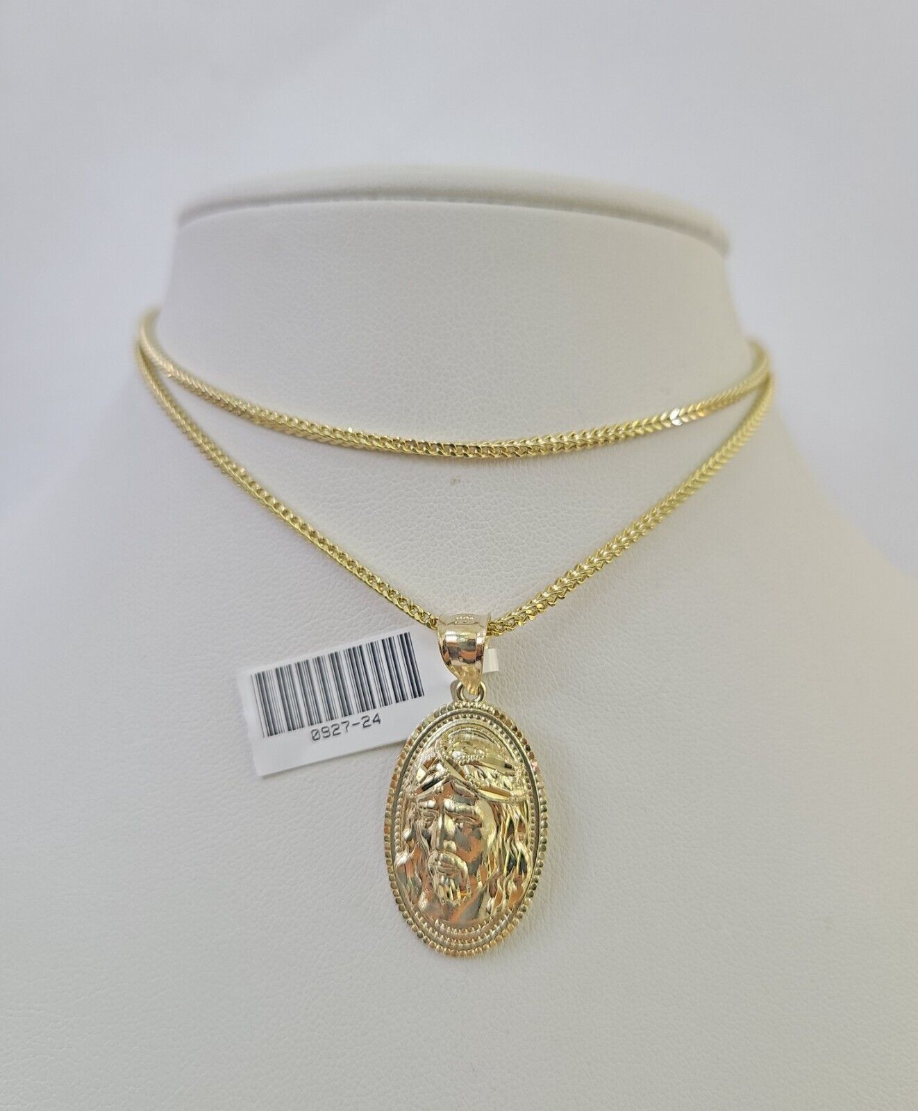 Front-facing view of Reva Jeweler 10K gold Jesus head pendant and chain