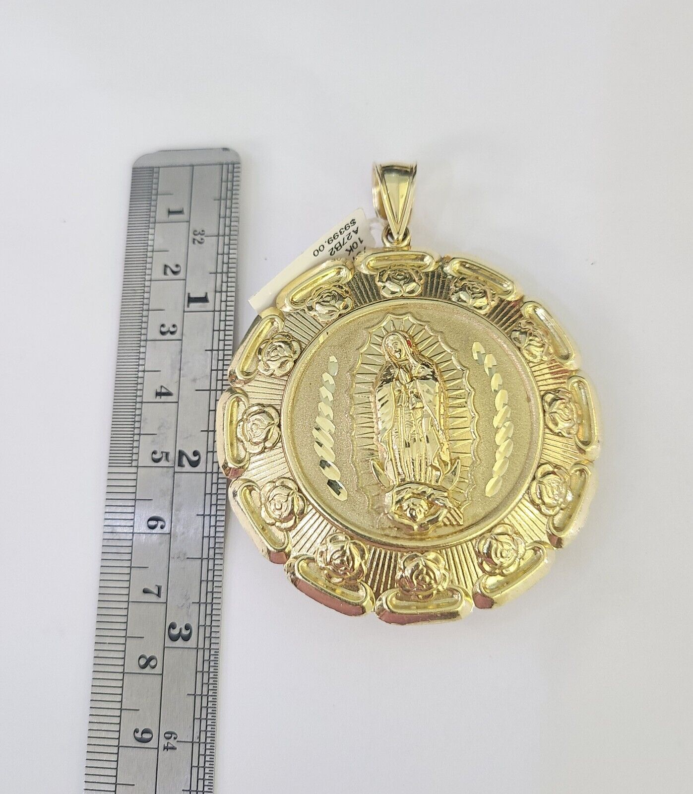 Side angle view of 10K yellow gold Jesus and Virgin Mary pendant on Franco chain