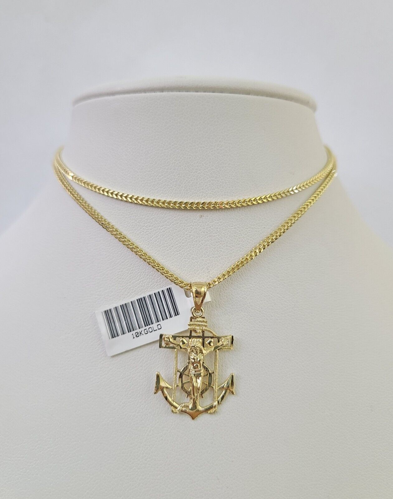 Close-up detail of Jesus anchor pendant in 10K gold jewelry design