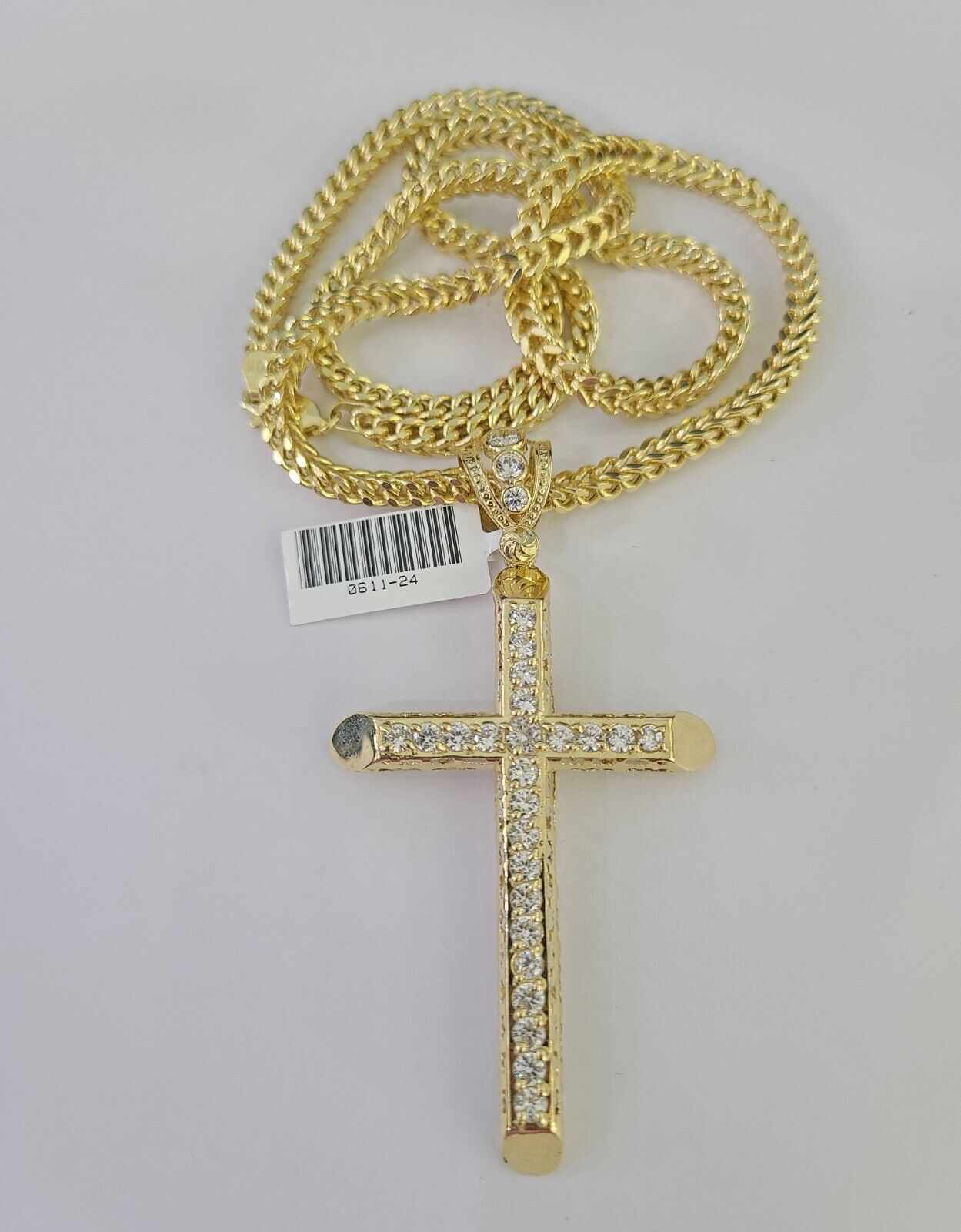 Full display of 10K yellow gold Franco chain with Jesus cross pendant