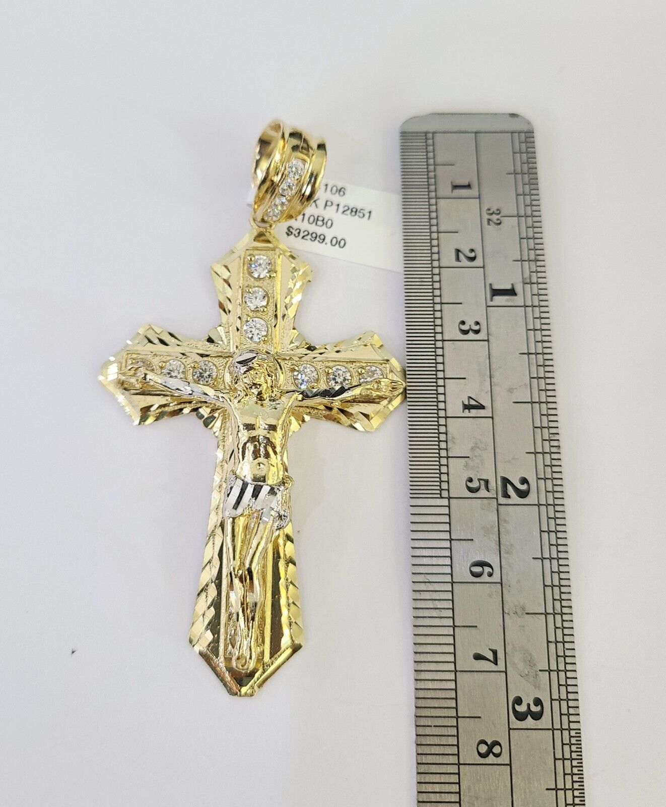 Flat lay shot of the 10K yellow gold jewelry set with cross pendant and Franco chain