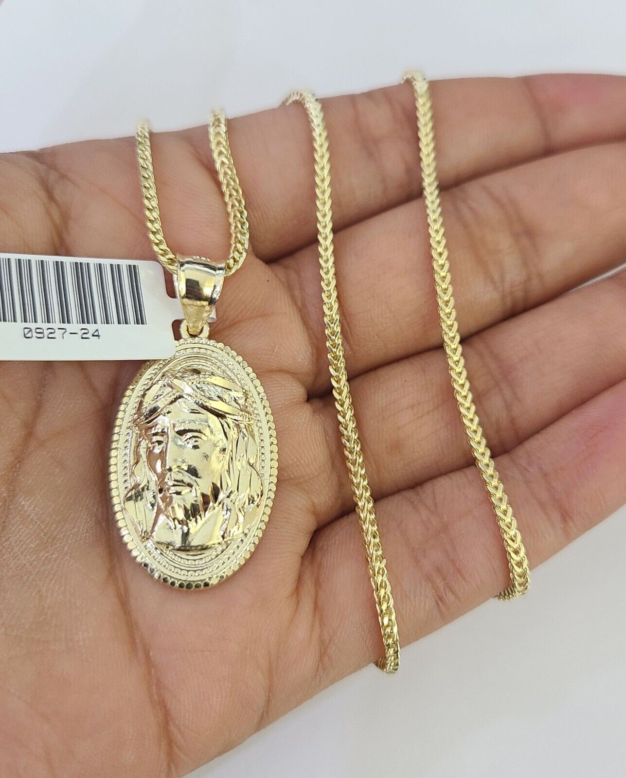 Close-up detailed view of 10K yellow gold Jesus head pendant charm