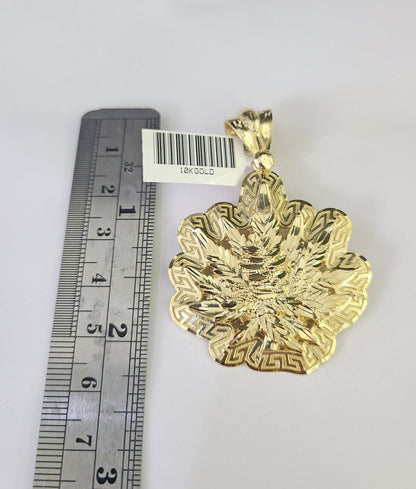 Close-up detailed view of 10K yellow gold weed leaf pendant charm