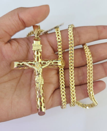 Side angle view of 10K yellow gold INRI Jesus cross pendant on Franco chain