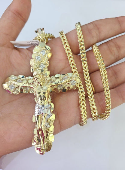 Flat lay display of Reva Jeweler 10K yellow gold crucifix necklace set