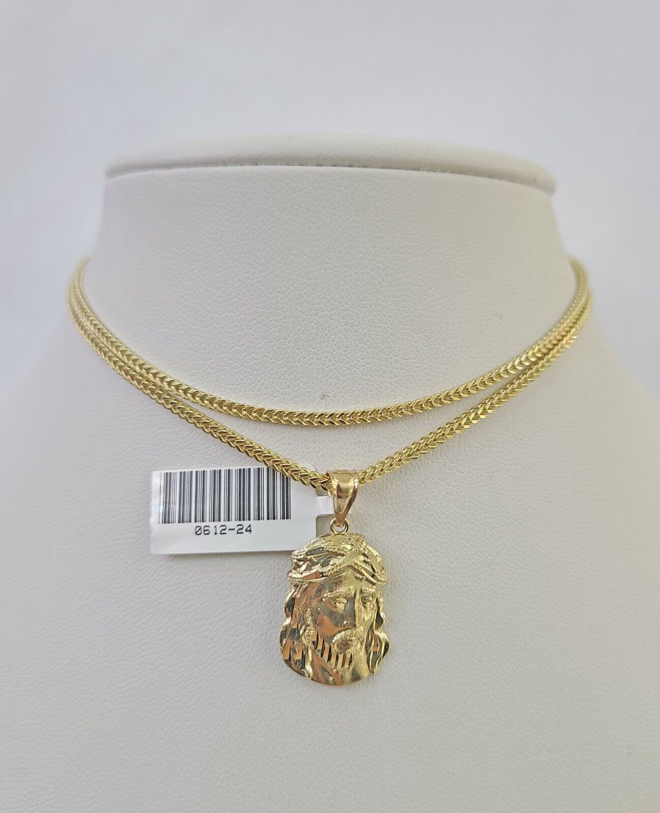 Side angle view of 10K yellow gold Jesus head pendant on Franco chain
