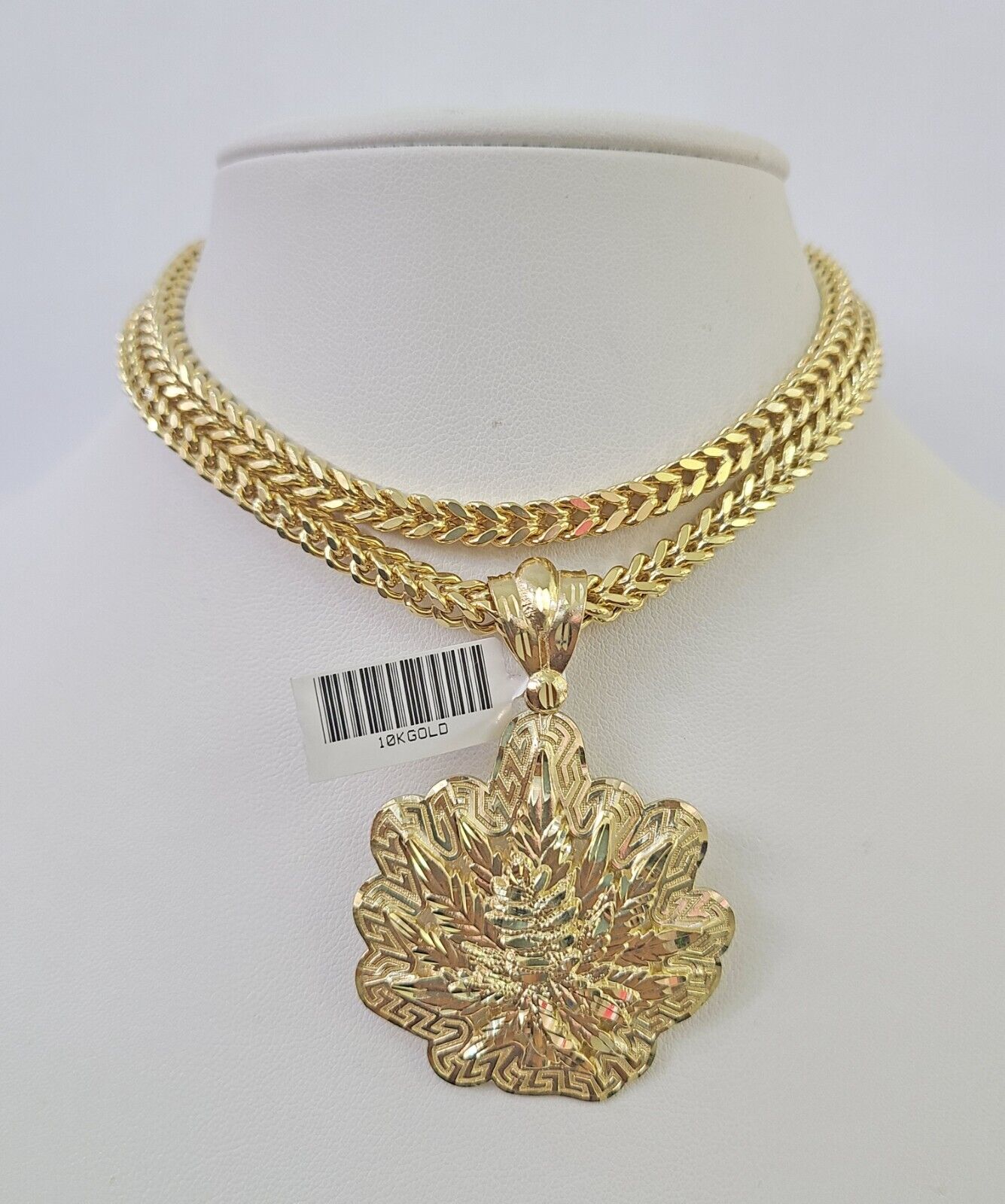 Full display of 10K yellow gold Franco chain with tree leaf pendant
