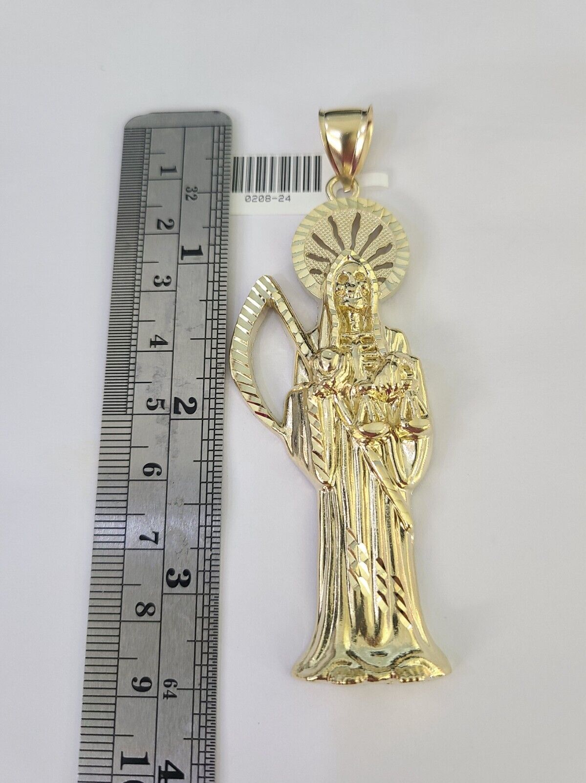Close-up detailed view of 10K yellow gold Saint Reaper pendant charm