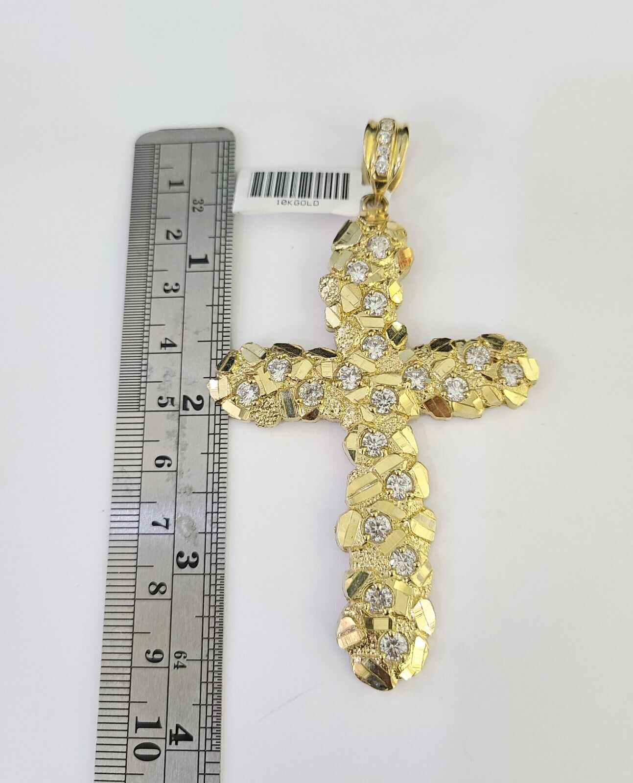 Close-up detailed view of 10K yellow gold Jesus cross pendant charm