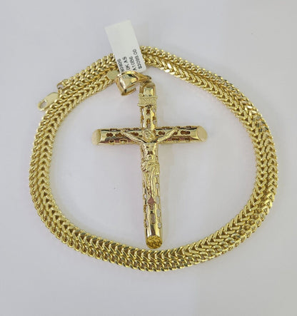 Flat lay display of Reva Jeweler 10K yellow gold INRI cross necklace set
