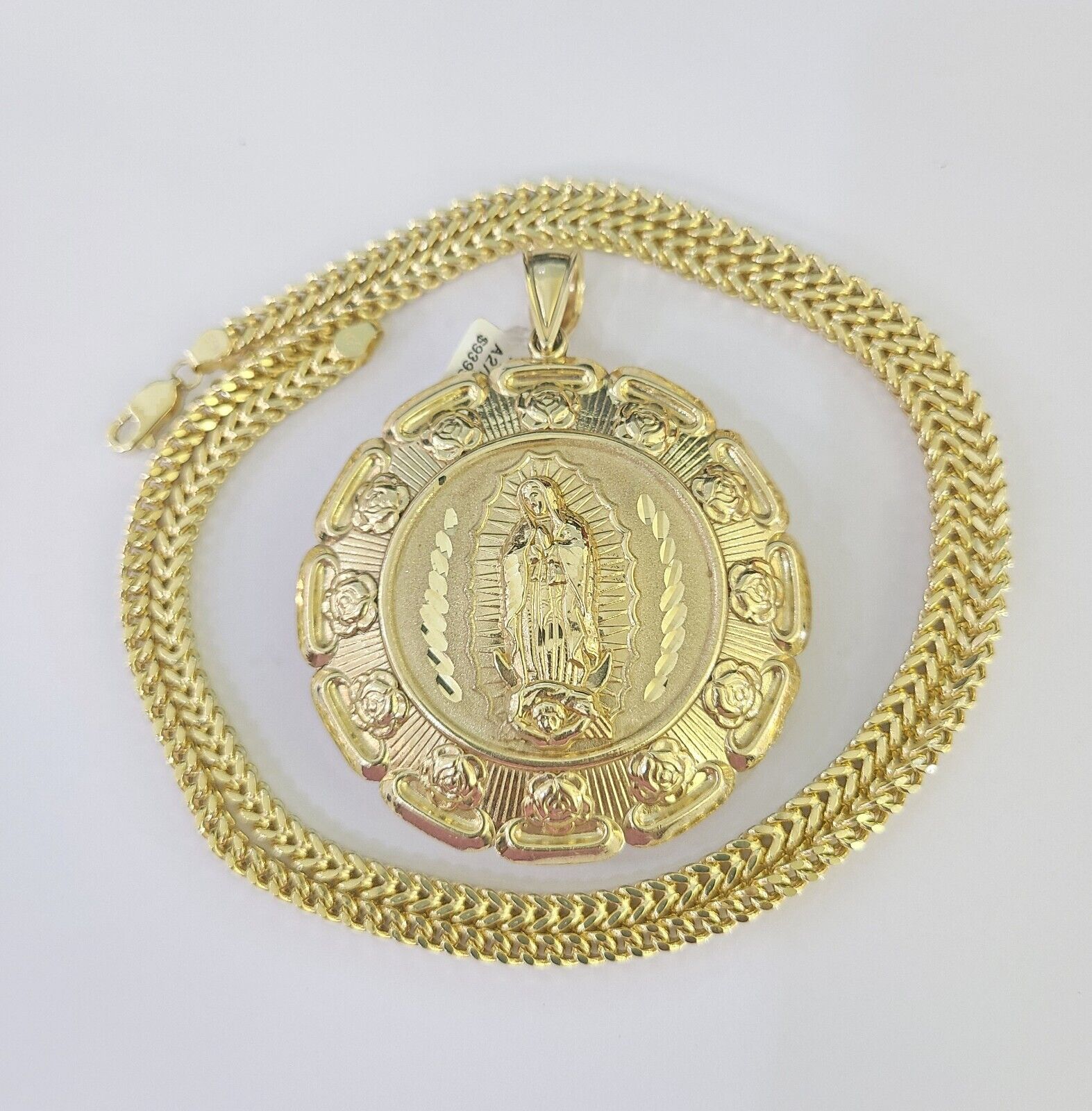 Close-up detailed view of 10K yellow gold Jesus and Virgin Mary pendant charm