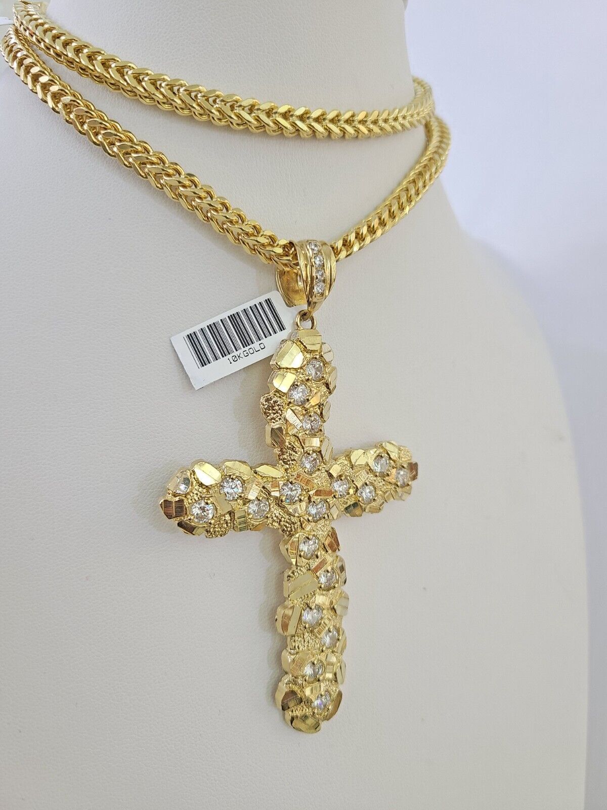 Full display of 10K yellow gold Franco chain with Jesus cross pendant