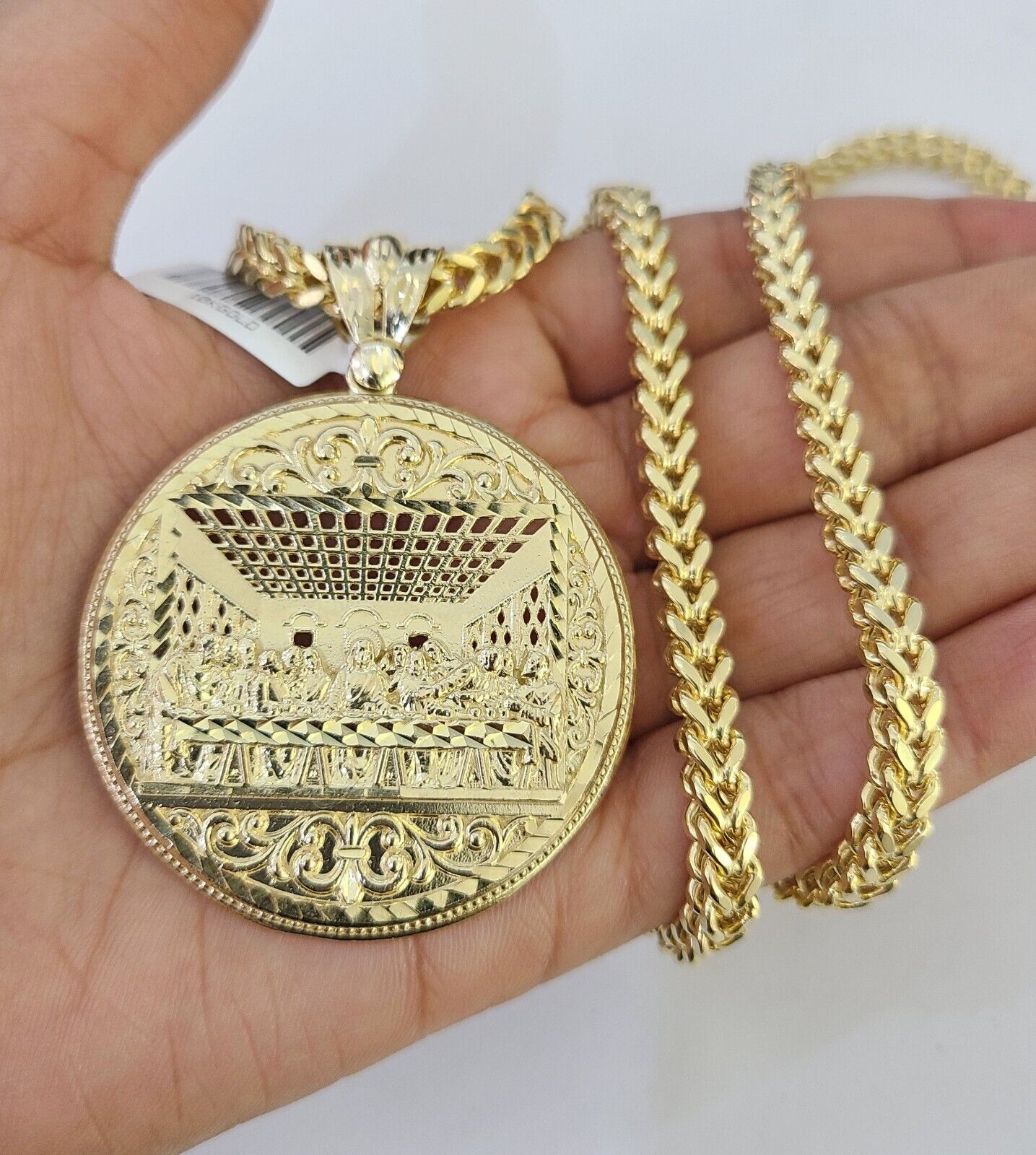 Side angle view of 10K yellow gold Last Supper pendant on Franco chain
