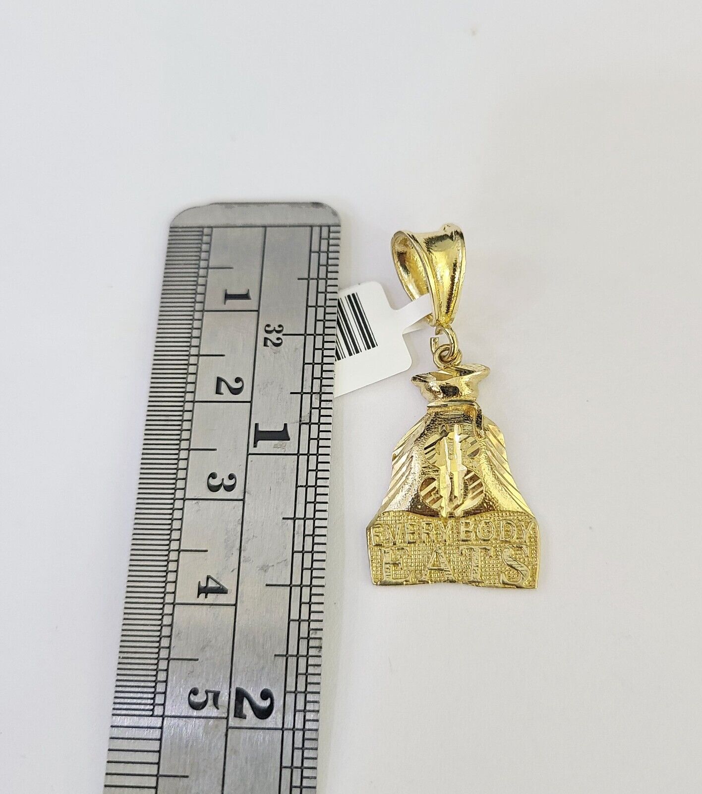 Close-up of 10K yellow gold “Everybody Eats” pendant on Franco chain necklace