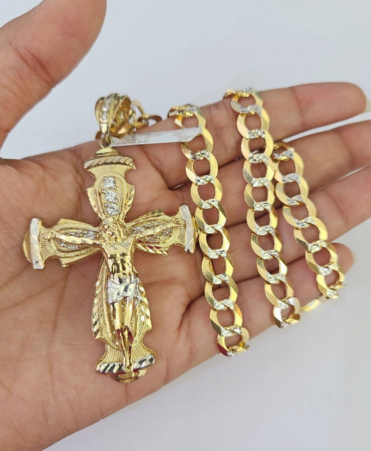 Flat lay of the 10k gold chain and cross charm set from Reva Jeweler