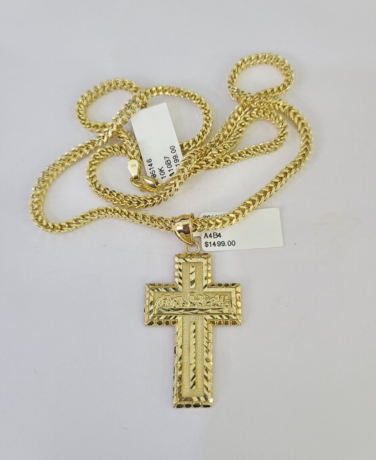 Close-up detailed view of 10K yellow gold Last Supper cross pendant charm