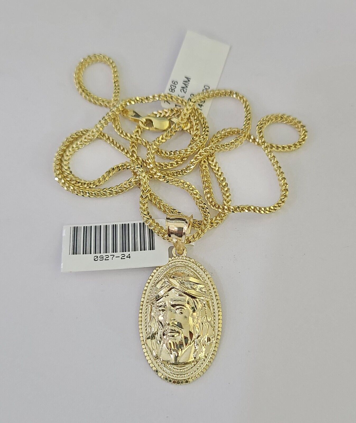 Lifestyle or alternate angle view of 10K gold Jesus head necklace by Reva Jeweler