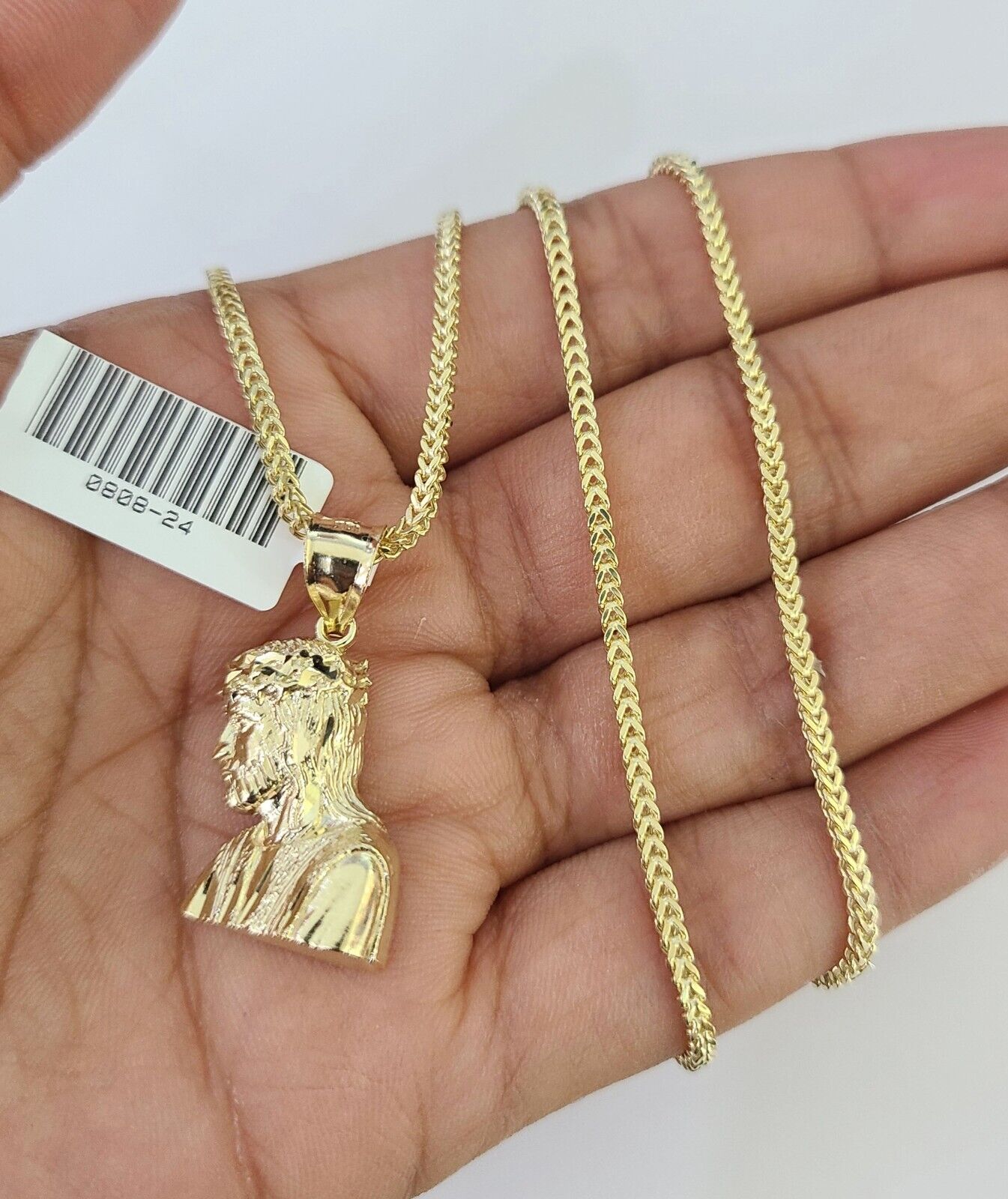 Front-facing view of Reva Jeweler 10K gold Jesus head pendant and chain