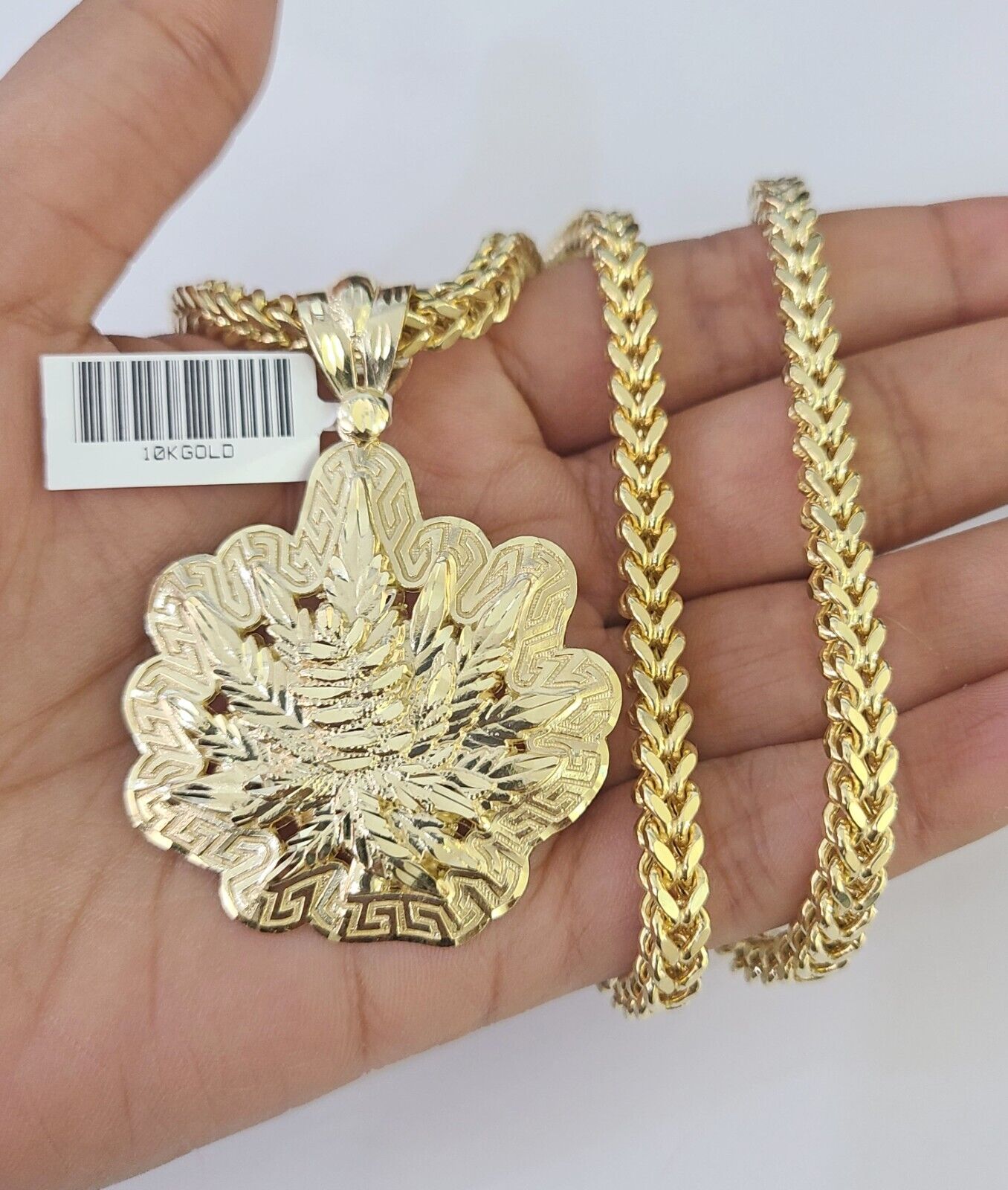 Front-facing view of Reva Jeweler 10K gold tree leaf pendant and chain
