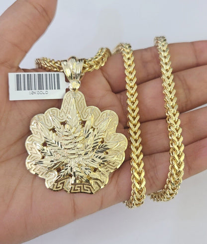 Front-facing view of Reva Jeweler 10K gold tree leaf pendant and chain