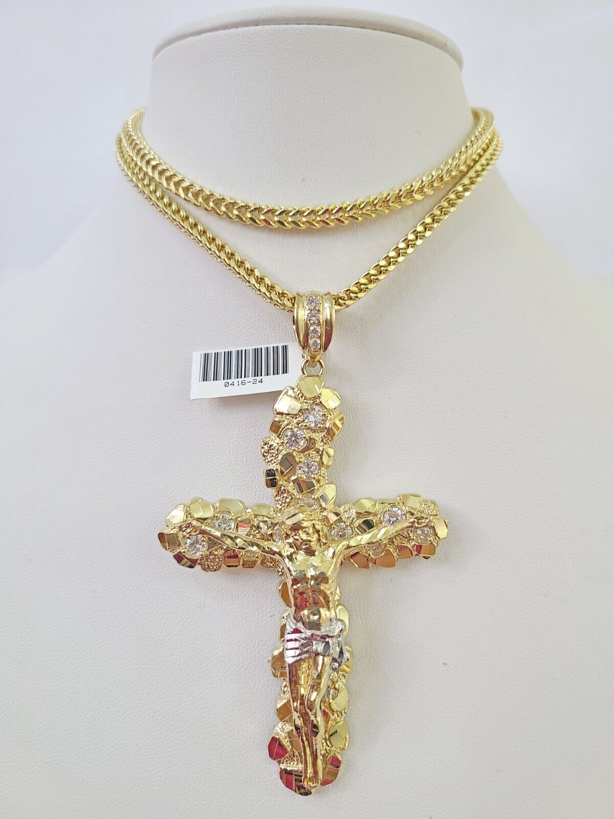 Front-facing view of Reva Jeweler 10K gold crucifix cross pendant and chain