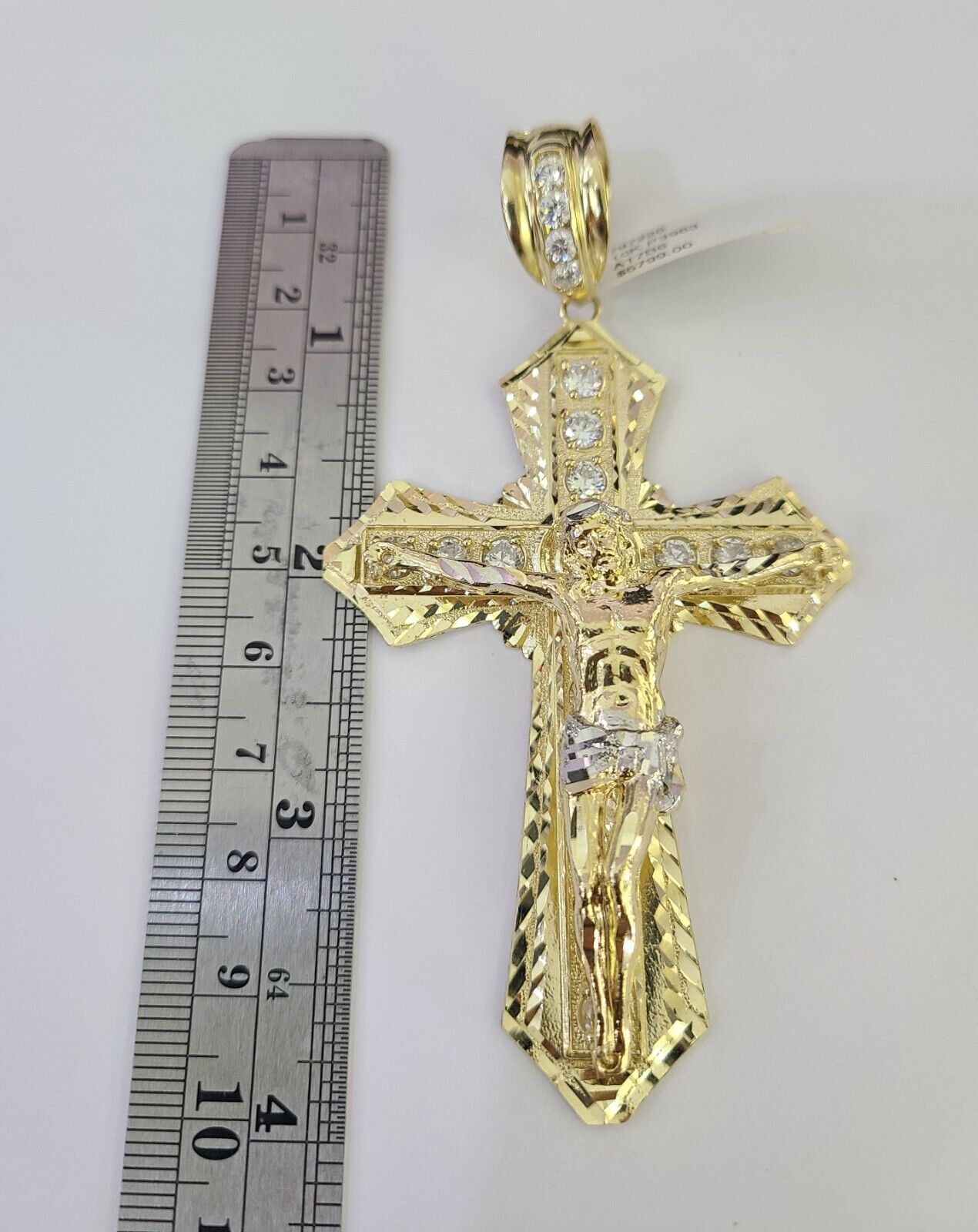 Front-facing view of the Reva Jeweler 10K gold cross pendant and chain set