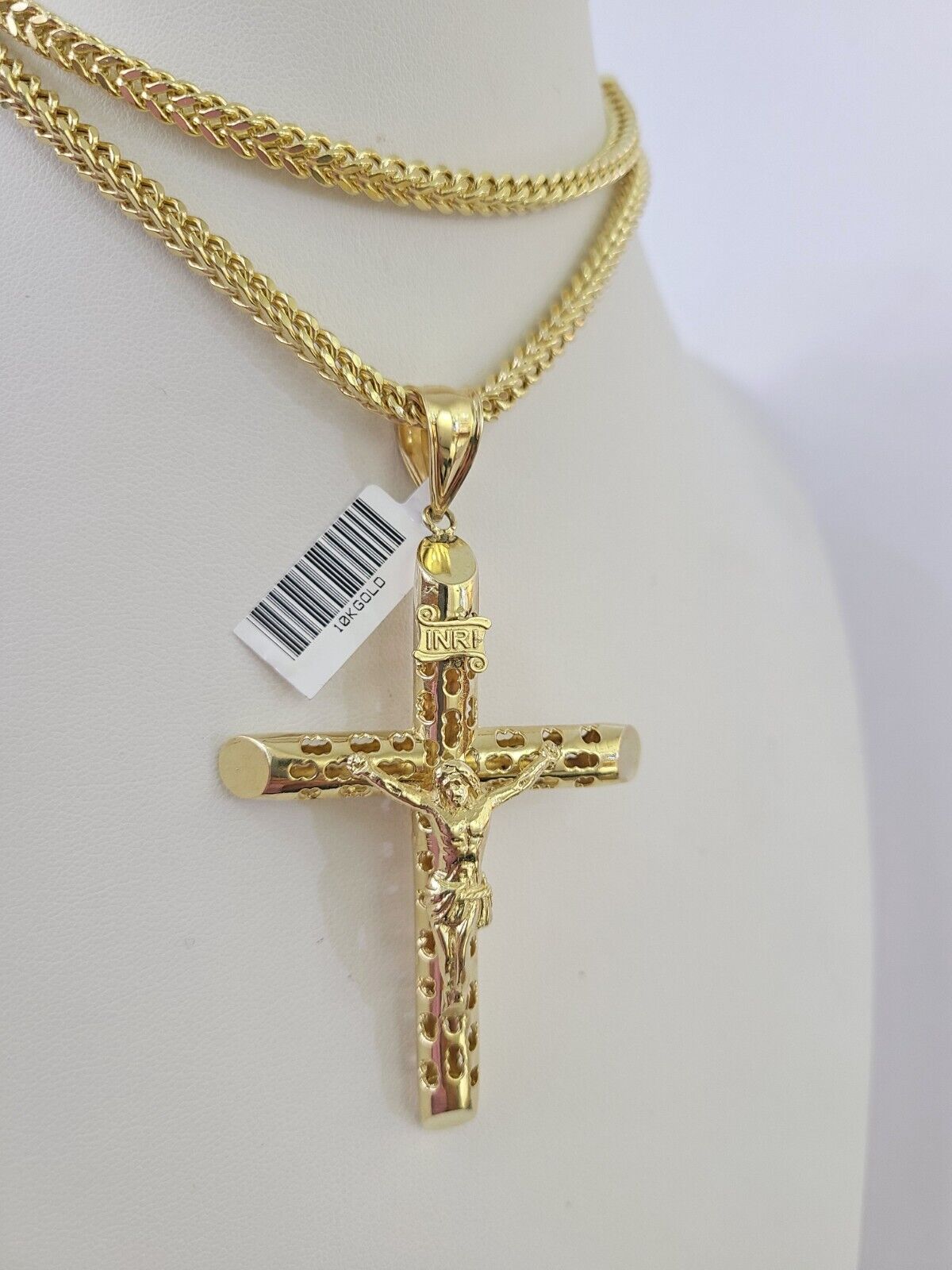 Front-facing view of Reva Jeweler 10K gold INRI cross pendant and chain
