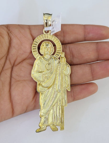 Flat lay display of Reva Jeweler 10K yellow gold Saint Jude necklace set