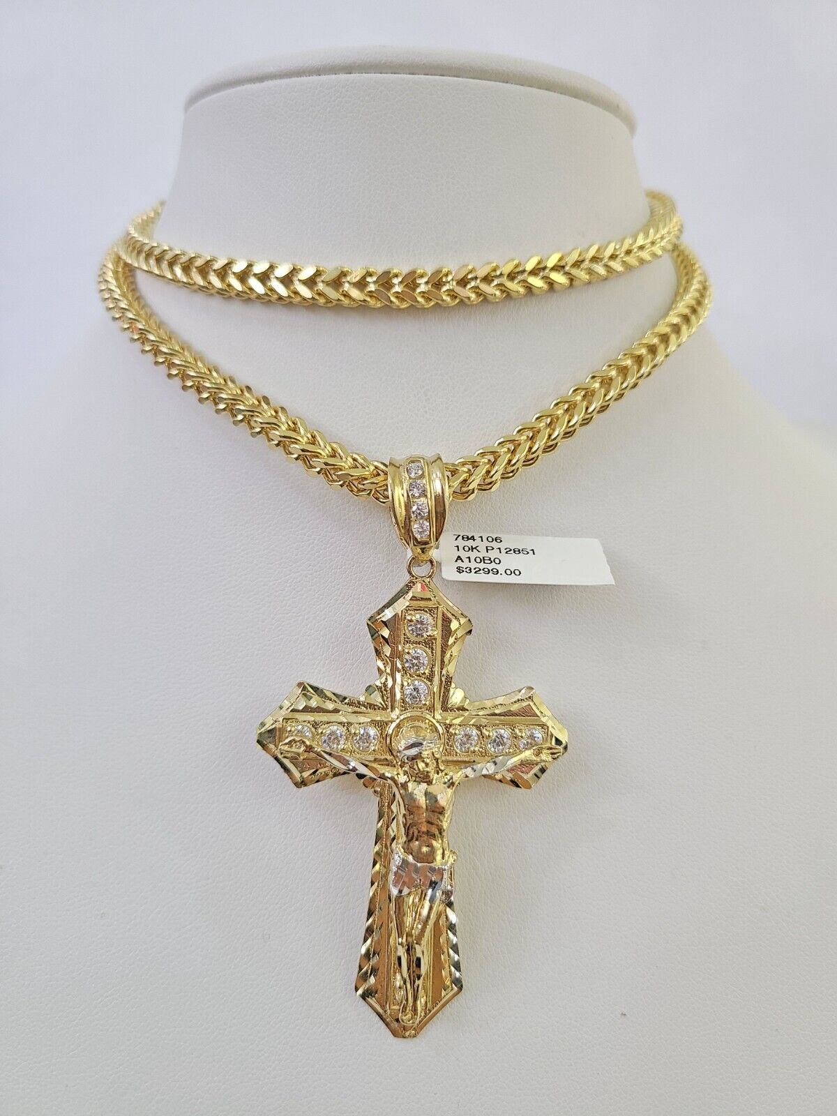 10K yellow gold Jesus cross pendant paired with a Franco chain necklace by Reva Jeweler