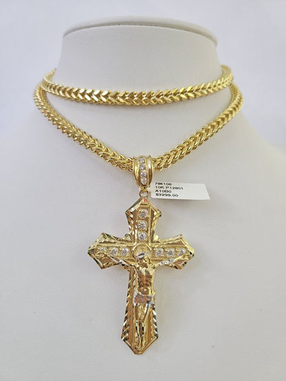 10K yellow gold Jesus cross pendant paired with a Franco chain necklace by Reva Jeweler