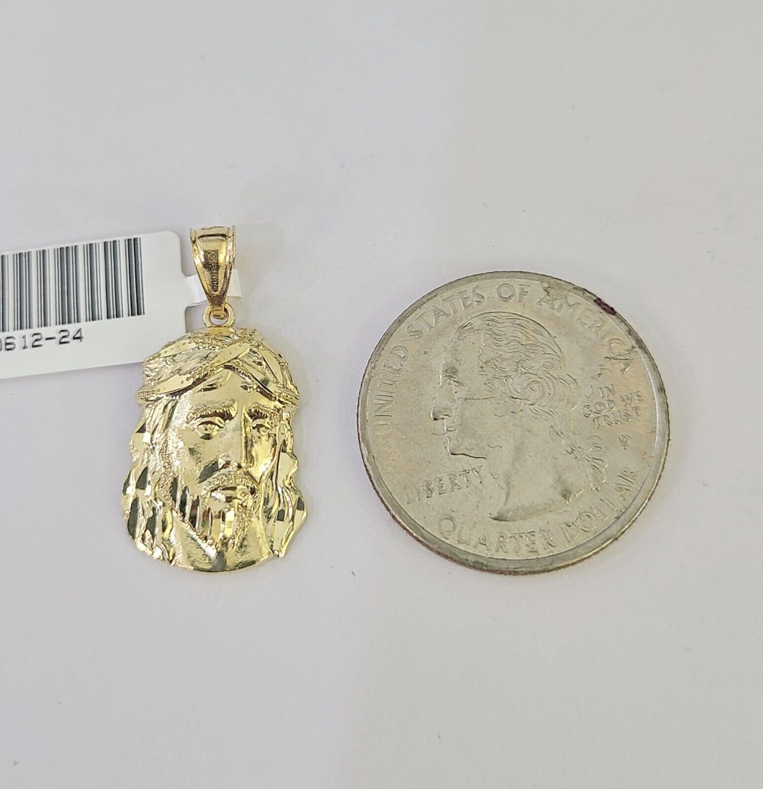 Close-up detailed view of 10K yellow gold Jesus head pendant charm