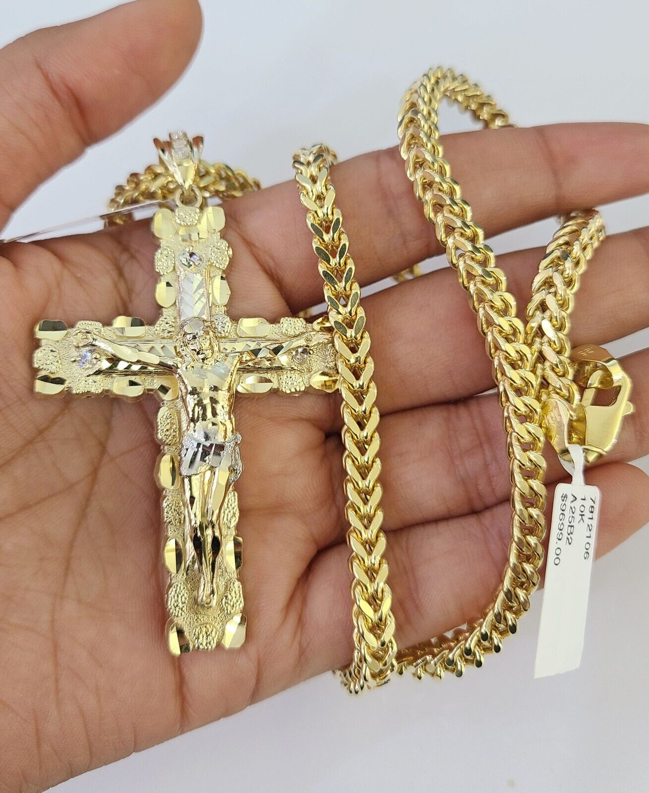 Close-up detailed view of 10K yellow gold Jesus cross pendant charm
