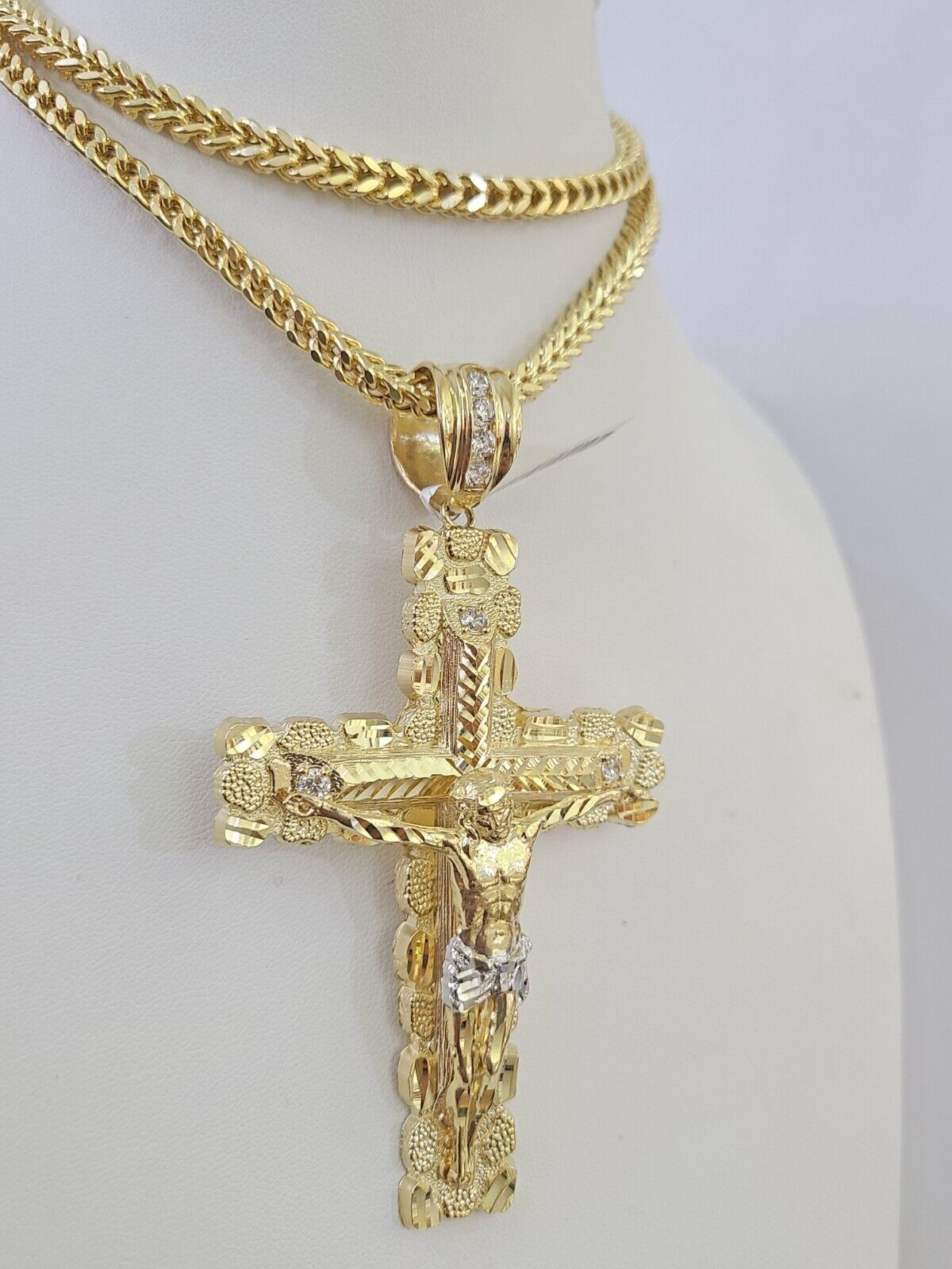 Full display of 10K yellow gold Franco chain with Jesus cross pendant