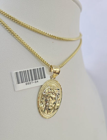 Flat lay display of Reva Jeweler 10K yellow gold Jesus head necklace set