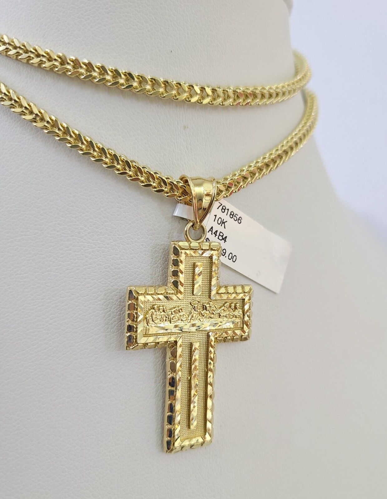 Side angle view of 10K yellow gold Last Supper cross pendant on Franco chain