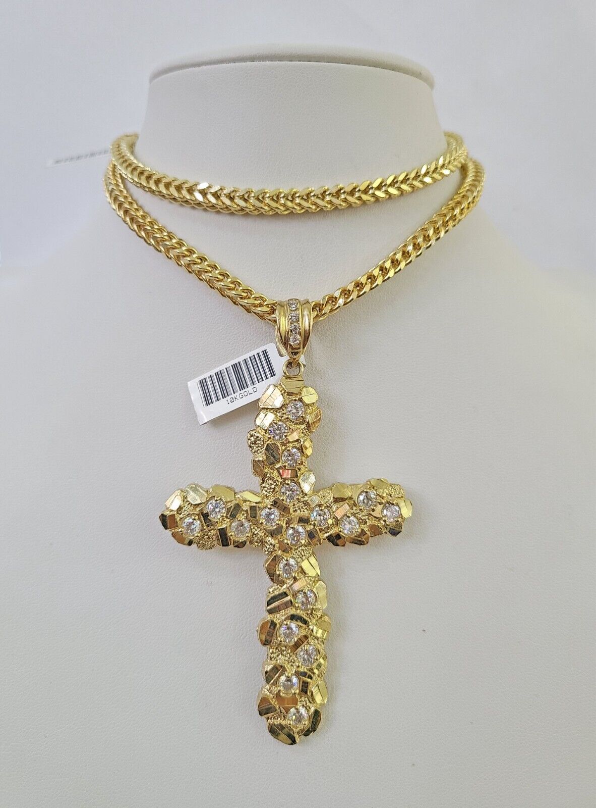 Side angle view of 10K yellow gold Jesus cross pendant on Franco chain