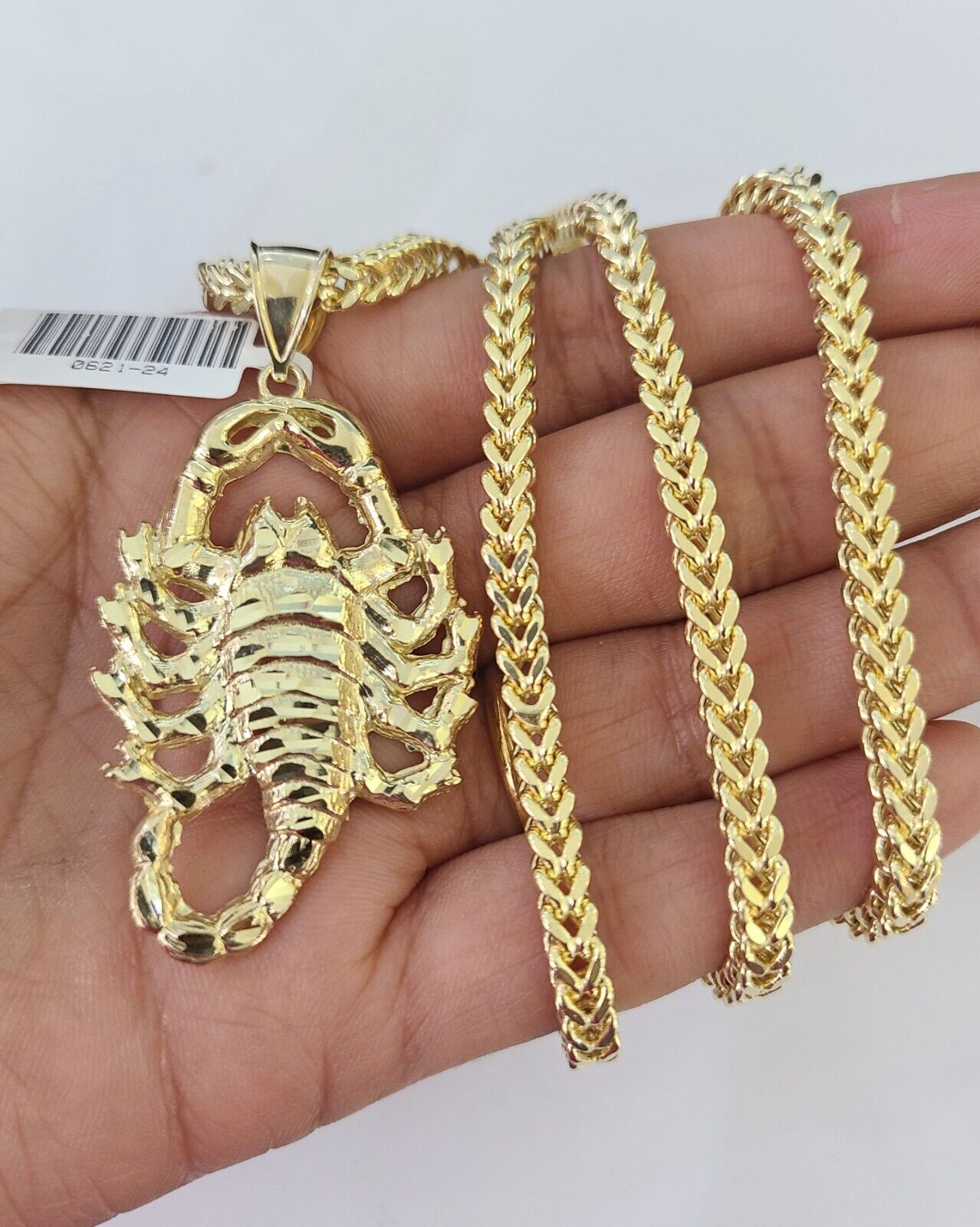 Side angle view of 10K yellow gold Scorpio pendant on Franco chain