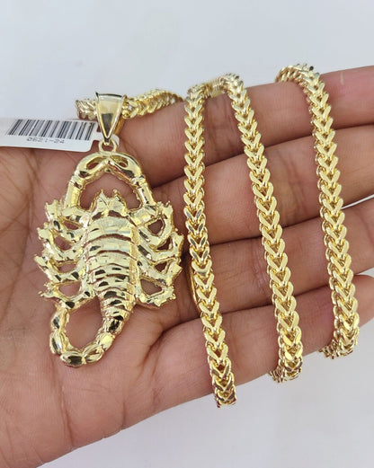 Side angle view of 10K yellow gold Scorpio pendant on Franco chain
