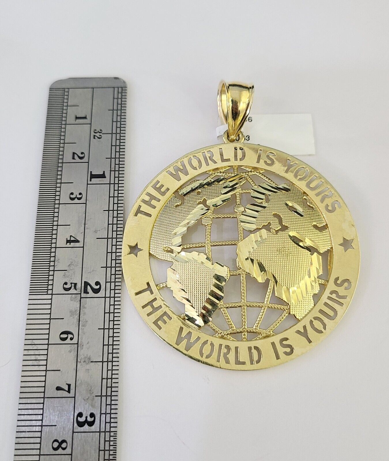 Full display of 10K gold Franco chain with "The World Is Yours" pendant