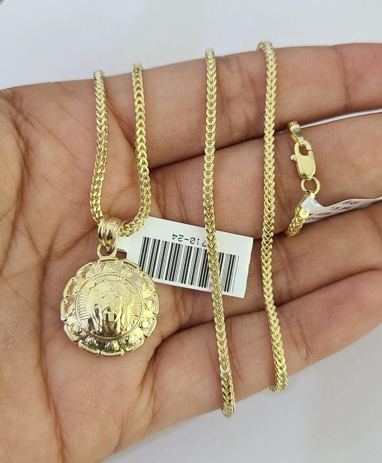 Front-facing view of Reva Jeweler 10K gold Jesus and Mary pendant and chain