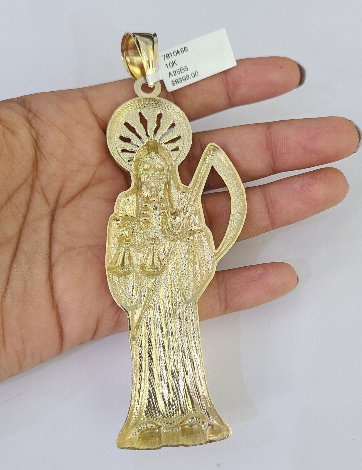 Front-facing view of Reva Jeweler 10K gold Saint Reaper pendant and chain
