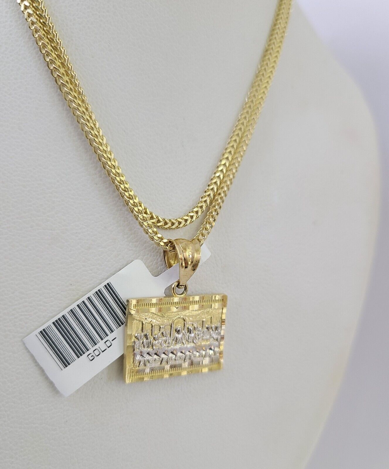 Side angle view of 10K gold Mayan calendar pendant on Franco chain