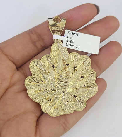Side angle view of 10K yellow gold tree leaf pendant on Franco chain