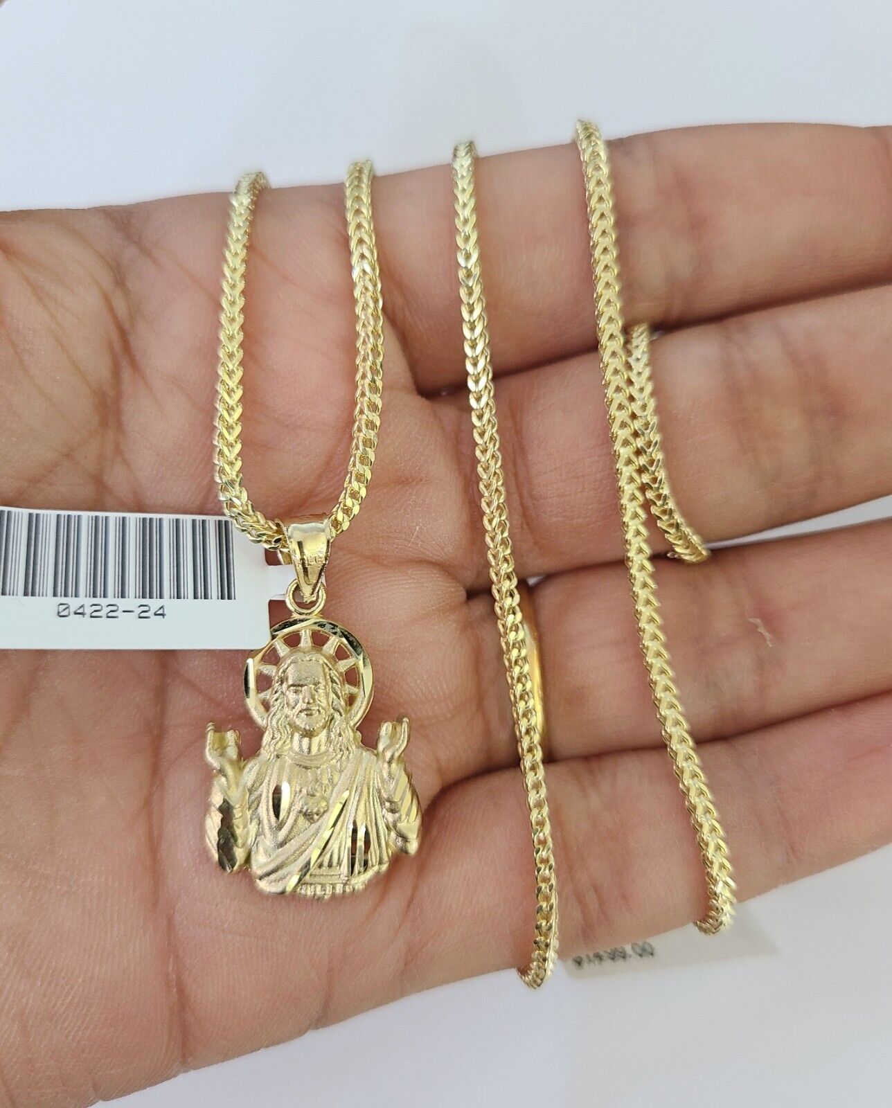 Close-up detailed view of 10K yellow gold Jesus pendant charm
