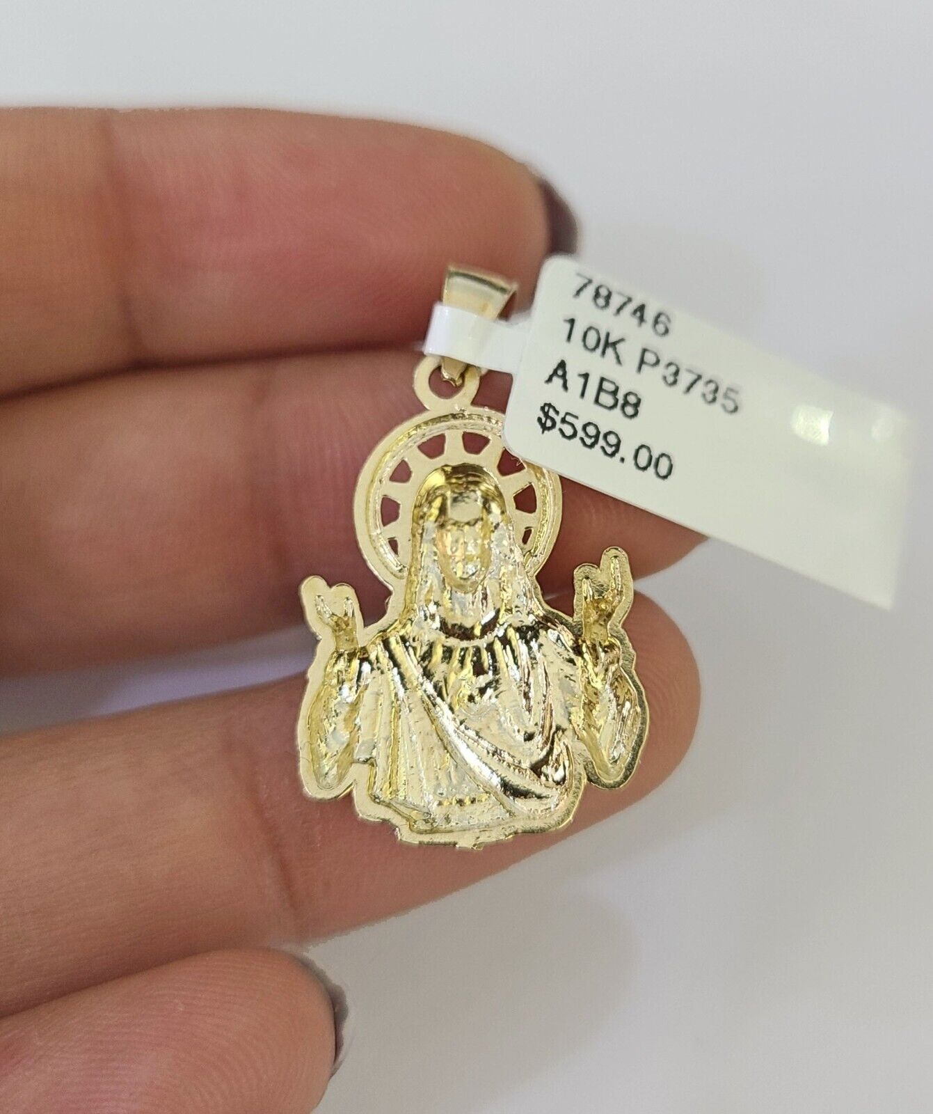 Side angle view of 10K yellow gold Jesus pendant on Franco chain